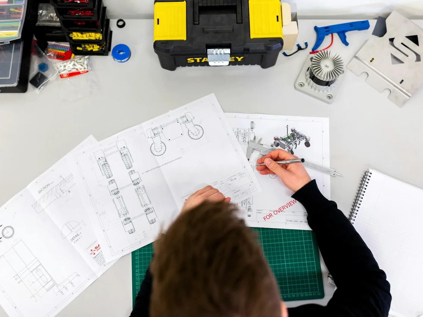 Engineering drawings and specifications on a desk